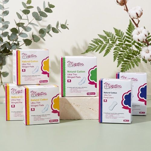 Maxim pure cotton ultra thin feminine care assortment featuring winged pads (10 regular, 8 super) and ultra thin panty liners (20 lite) with organic top sheet, shown as multiple boxes on white background.
