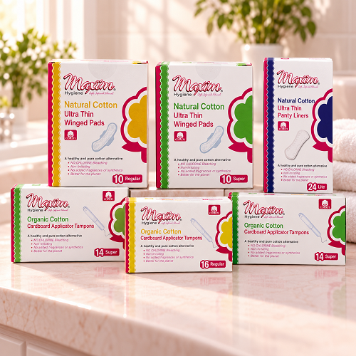 Maxim organic cotton feminine care product lineup featuring cardboard applicator tampons (regular and super), pure cotton ultra thin winged pads (regular and super), and ultra thin panty liners (20 lite) on white background.