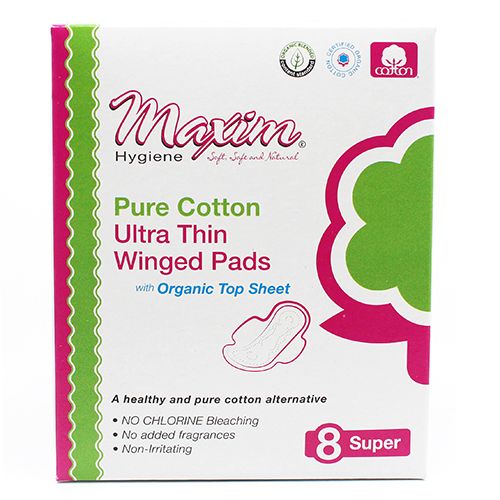 Front of a Maxim Hygiene box labeled ‘Pure Cotton Ultra Thin Winged Pads’ with ‘Organic Top Sheet,’ featuring a white background with pink/green accents, a large green flower graphic, and a badge showing ‘8 Super,’ plus claims like ‘No chlorine bleaching’